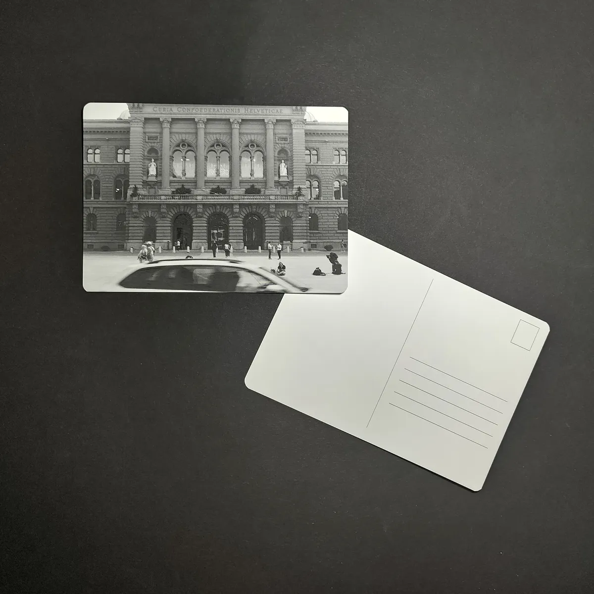 August Postcard - Black-and-white view of the Bundeshaus facade and Bundesplatz in Bern